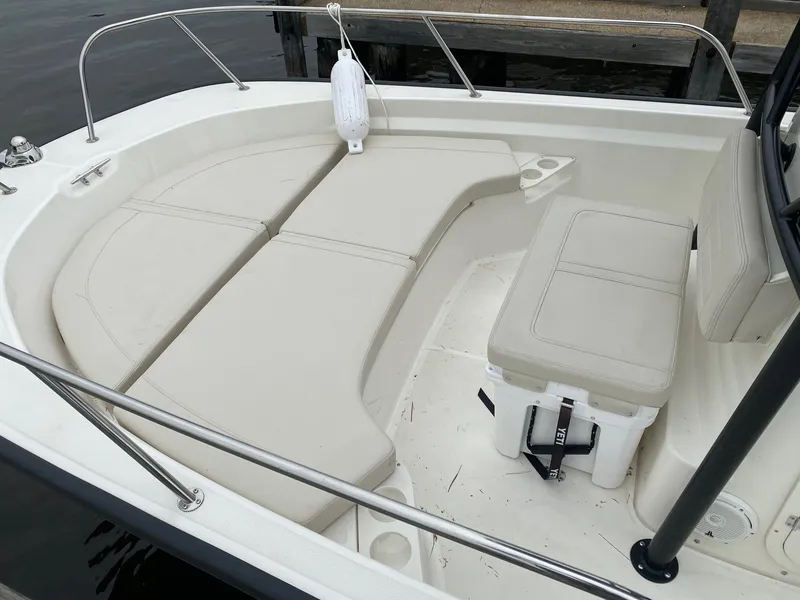 Slide: The Image of 2023 Boston Whaler 190 Montauk boat interior with cushioned seating and railing. - 13