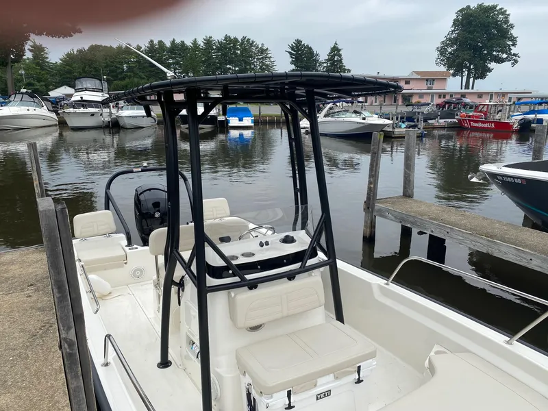Slide: The Image of 2023 Boston Whaler 190 Montauk docked at a marina with other boats. - 19