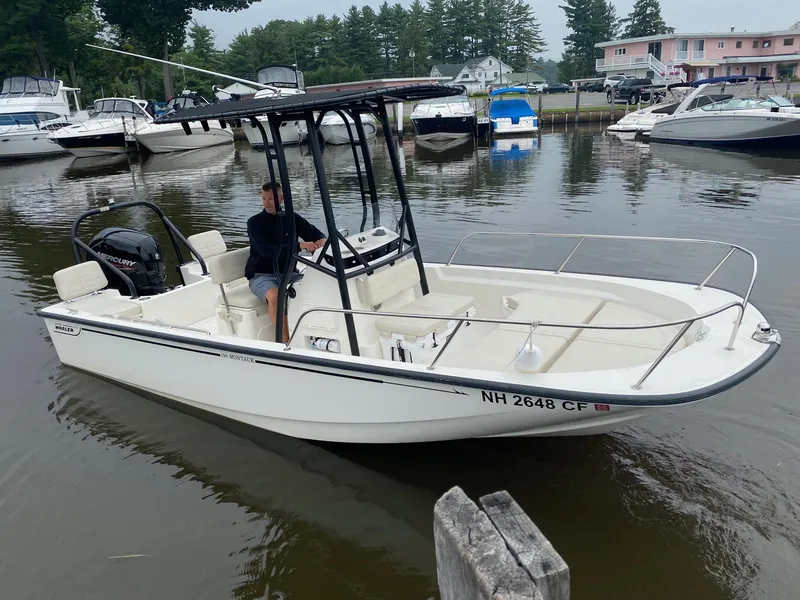 Slide: The Image of 2023 Boston Whaler 190 Montauk boat on a calm marina with other boats. - 5
