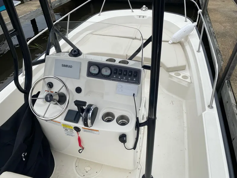 Slide: The Image of 2023 Boston Whaler 190 Montauk boat interior with steering console and seating. - 6