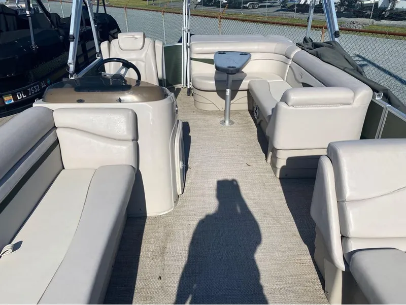 Slide: The Image of 2017 Bennington 22 SLX pontoon boat interior with beige seating and steering console. - 14