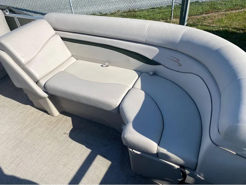 Slide: The Image of 2017 Bennington 22 SLX boat interior with beige seating and carpeted floor. - 2