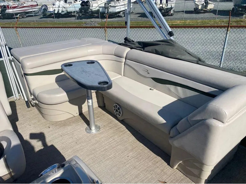 Slide: The Image of 2017 Bennington 22 SLX boat interior with beige seating and a small table. - 6