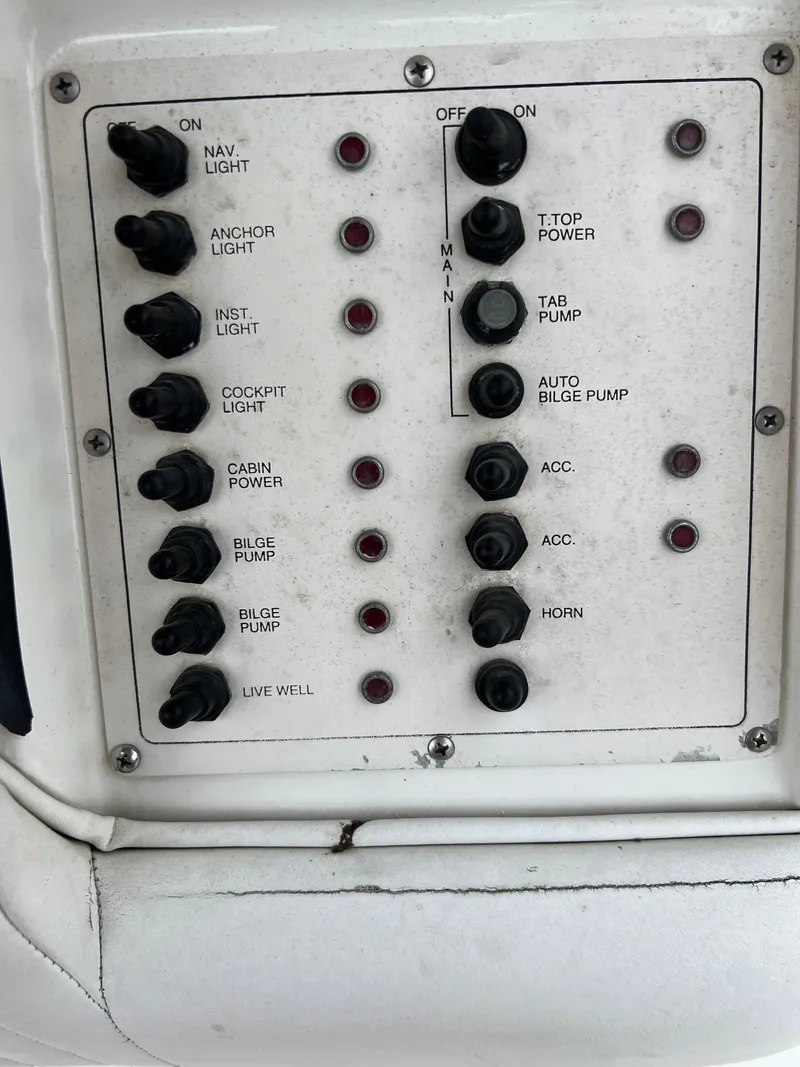 Slide: The Image of Control panel of a 1998 Fountain 31 CC boat with various switches and indicators. - 11
