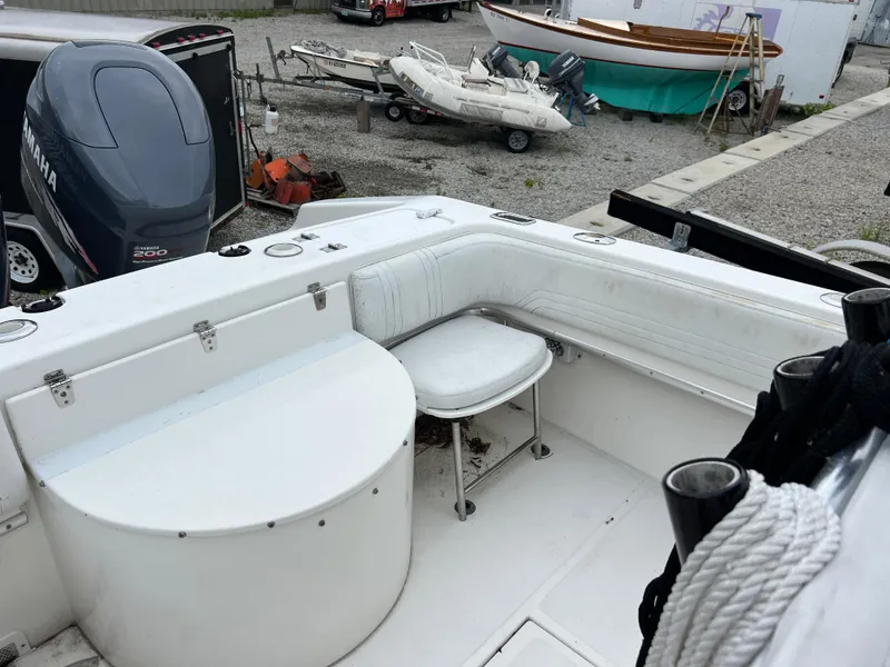 Slide: The Image of 1998 Fountain 31 CC boat interior with Yamaha engine, docked near other boats. - 16