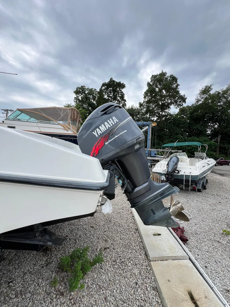 Slide: The Image of 1998 Fountain 31 CC boat with Yamaha outboard motor on gravel lot. - 7