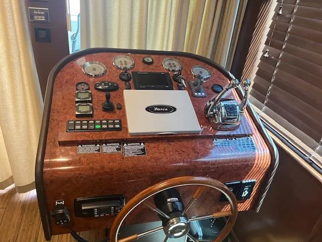 Slide: The Image of Control panel of a 2010 Stardust Cruisers houseboat with steering wheel and gauges. - 10