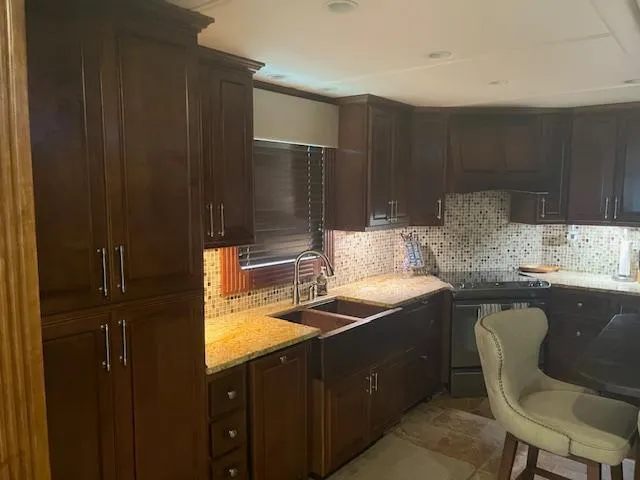 Slide: The Image of Luxurious kitchen interior of 2010 Stardust Cruisers houseboat with dark wood cabinets and modern appliances. - 16