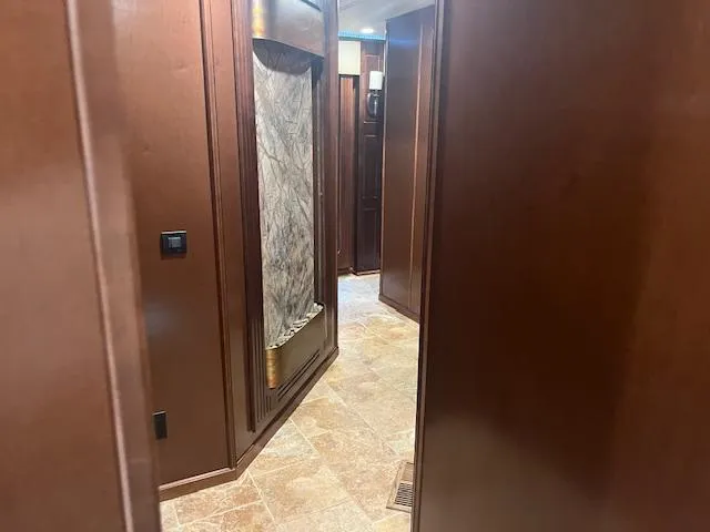 Slide: The Image of Interior hallway of 2010 Stardust Cruisers houseboat with wood paneling and tiled floor. - 19