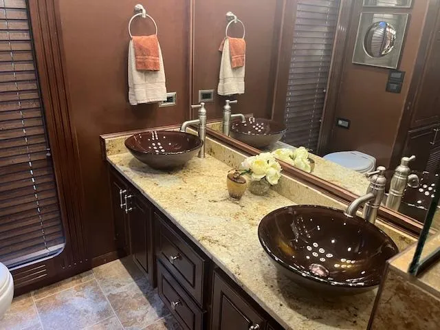 Slide: The Image of Luxurious 2010 Stardust Cruisers houseboat bathroom with dual vessel sinks and elegant decor. - 22