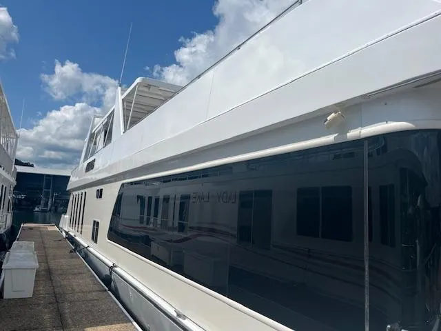 Slide: The Image of 2010 Stardust Cruisers houseboat docked under a blue sky. - 3