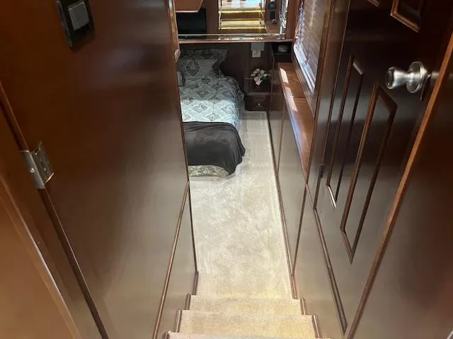 Slide: The Image of Interior of 2010 Stardust Cruisers houseboat, showing stairs leading to a cozy bedroom. - 31