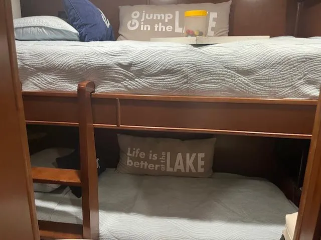 Slide: The Image of Bunk beds in a 2010 Stardust Cruisers houseboat with lake-themed pillows. - 34