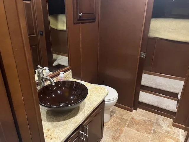 Slide: The Image of Luxurious bathroom in 2010 Stardust Cruisers houseboat with modern sink and elegant wood cabinetry. - 39