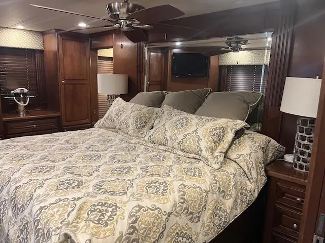 Slide: The Image of Luxurious bedroom interior of 2010 Stardust Cruisers houseboat with elegant bedding and wooden furnishings. - 41