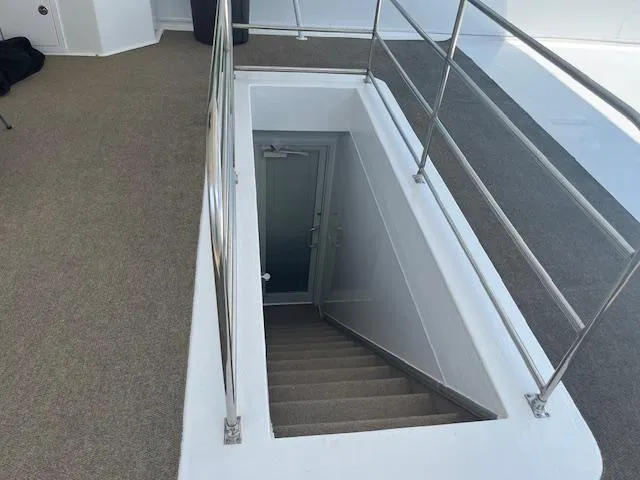 Slide: The Image of Staircase on 2010 Stardust Cruisers houseboat, featuring metal railings and carpeted steps. - 49