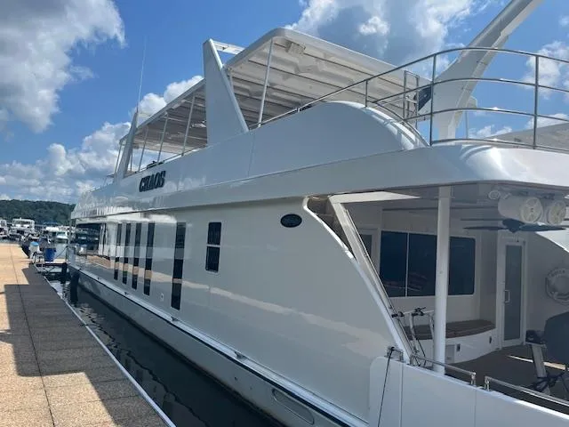 Slide: The Image of 2010 Stardust Cruisers houseboat docked under a blue sky. - 5