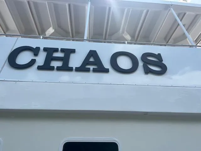 Slide: The Image of Stardust Cruisers 2010 houseboat named "CHAOS" with white exterior and bold lettering. - 6