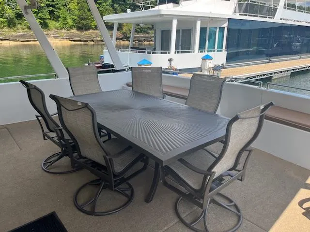 Slide: The Image of Outdoor dining area on 2010 Stardust Cruisers houseboat with six chairs and table. - 8