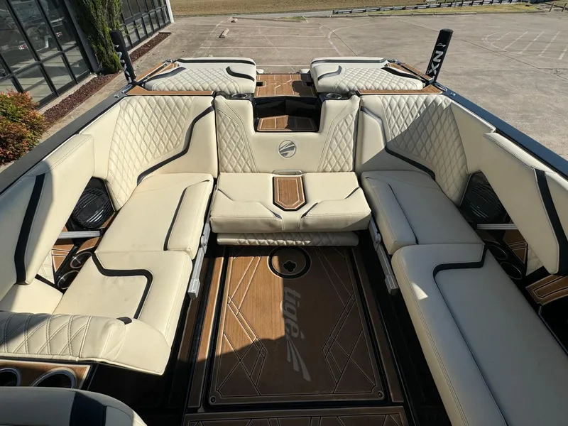 Slide: The Image of Luxurious interior of 2024 Tigé 24RZX boat with beige seating and wood accents. - 10