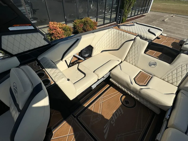 Slide: The Image of Luxurious interior of 2024 Tigé 24RZX boat with beige leather seating and wood accents. - 11