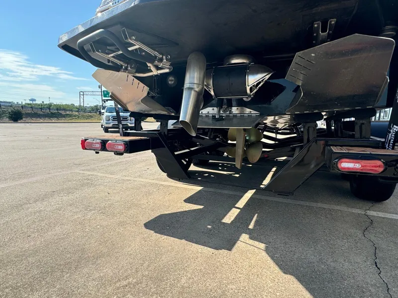 Slide: The Image of 2024 Tigé 24RZX boat trailer with propeller and exhaust system in a parking lot. - 4