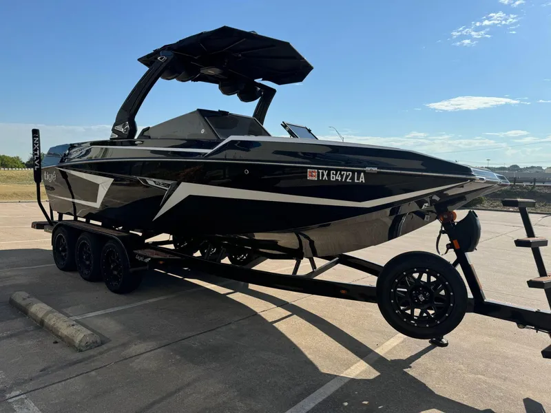 Slide: The Image of 2024 Tigé 24RZX boat on trailer in parking lot, sunny day. - 5