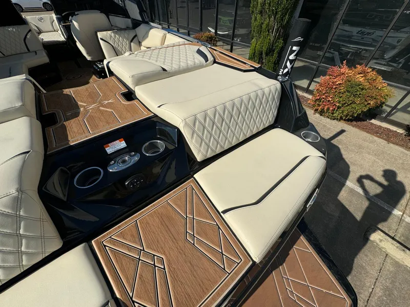 Slide: The Image of 2024 Tigé 24RZX boat interior with beige seating and wood-patterned flooring. - 8