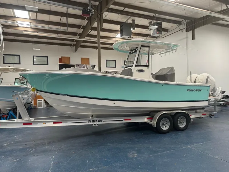 Slide: The Image of 2022 Regulator 25 boat on trailer in indoor storage facility. - 1