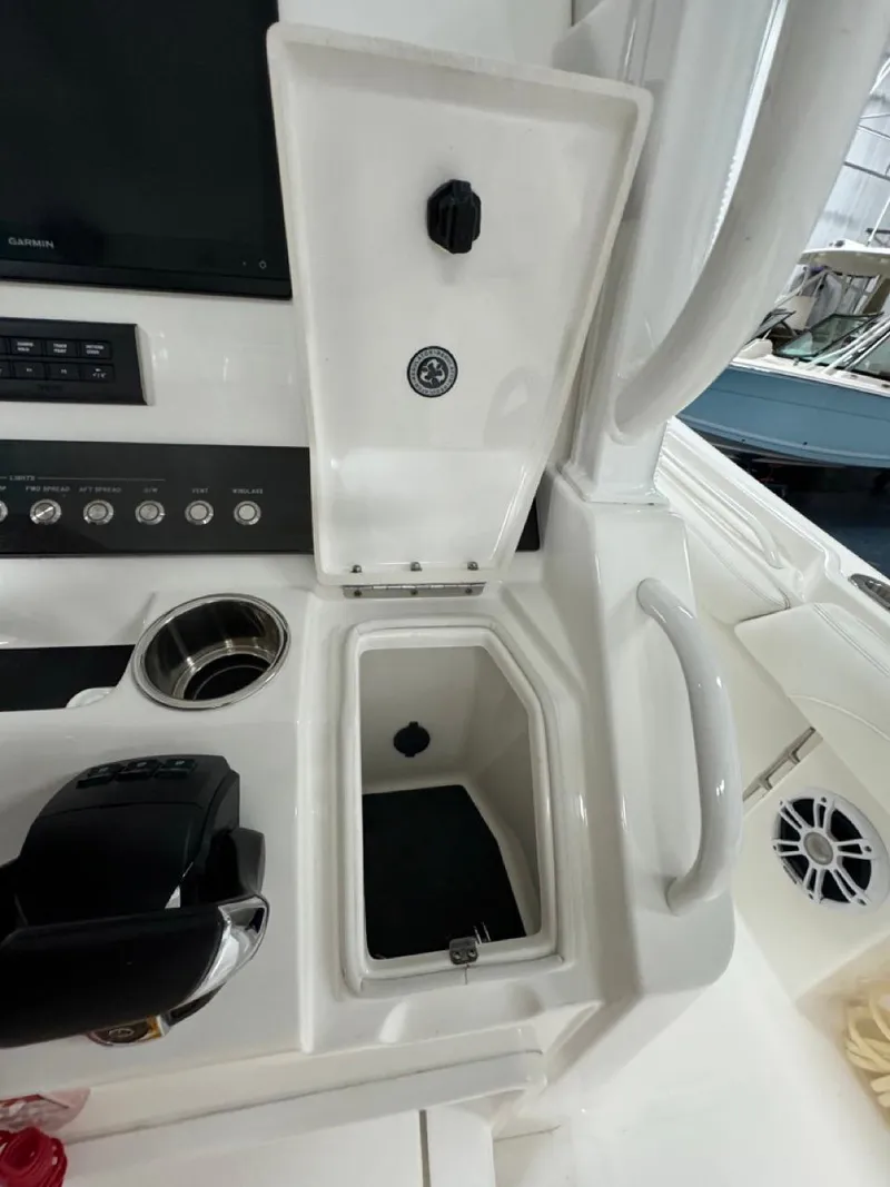 Slide: The Image of 2022 Regulator 25 boat console with storage compartment and control panel. - 13