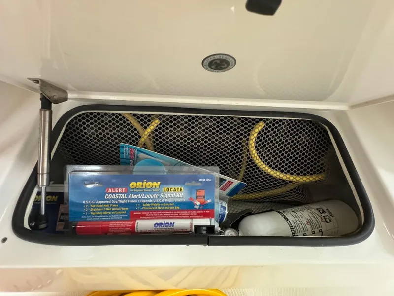 Slide: The Image of Storage compartment in 2022 Regulator 25 boat with safety equipment and supplies. - 14