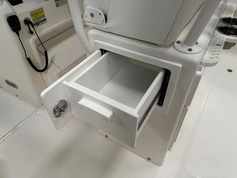 Slide: The Image of 2022 Regulator 25 boat storage compartment with open drawer. - 15