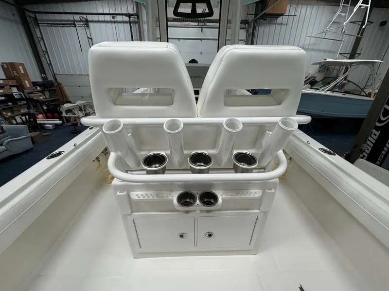 Slide: The Image of 2022 Regulator 25 boat interior with rod holders and storage compartments. - 16