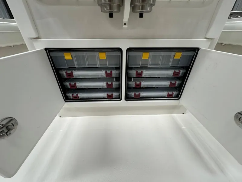 Slide: The Image of 2022 Regulator 25 boat storage compartments with organized tackle boxes. - 17