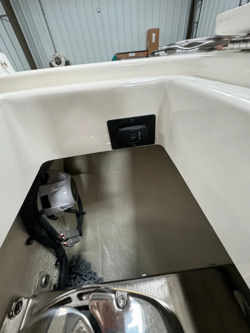 Slide: The Image of 2022 Regulator 25 boat interior storage compartment with equipment. - 19