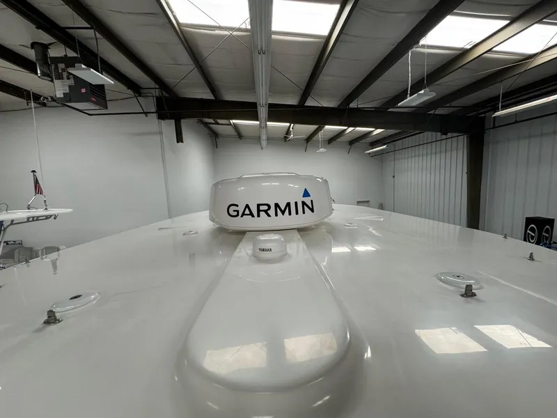Slide: The Image of 2022 Regulator 25 boat with Garmin radar in a warehouse setting. - 20