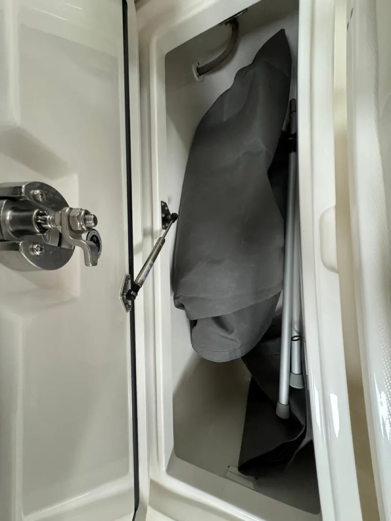 Slide: The Image of Storage compartment of 2022 Regulator 25 boat with equipment inside. - 23