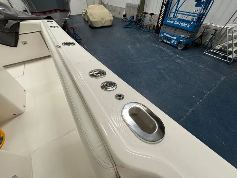 Slide: The Image of 2022 Regulator 25 boat interior with rod holders in a storage facility. - 25