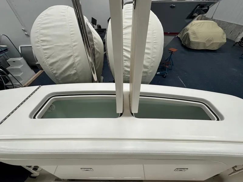 Slide: The Image of 2022 Regulator 25 boat interior with open storage compartment in a workshop setting. - 27
