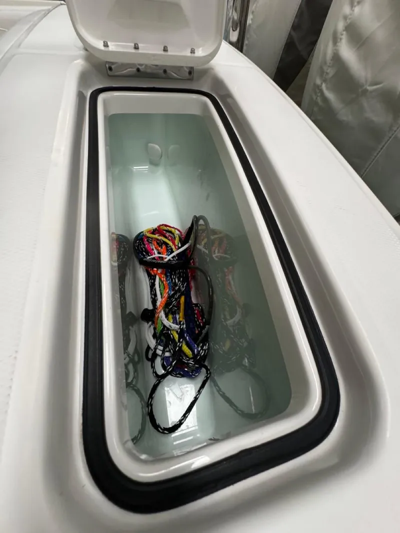 Slide: The Image of Open storage compartment on 2022 Regulator 25 boat with colorful ropes inside. - 28