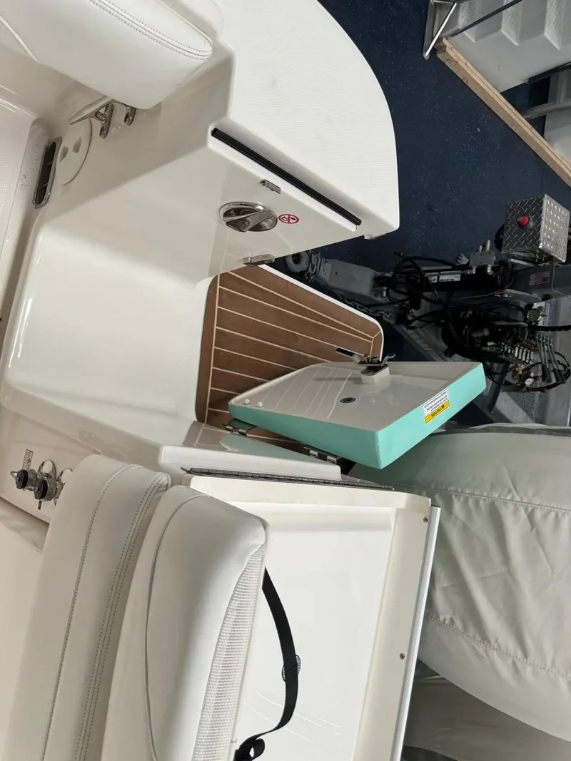 Slide: The Image of 2022 Regulator 25 boat interior with white seating and wooden flooring. - 29