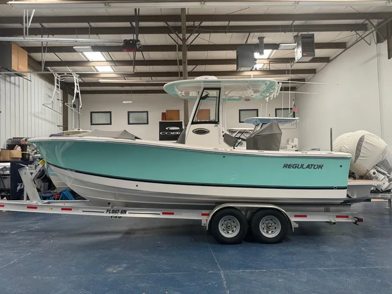 Slide: The Image of 2022 Regulator 25 boat on trailer in indoor storage facility. - 3