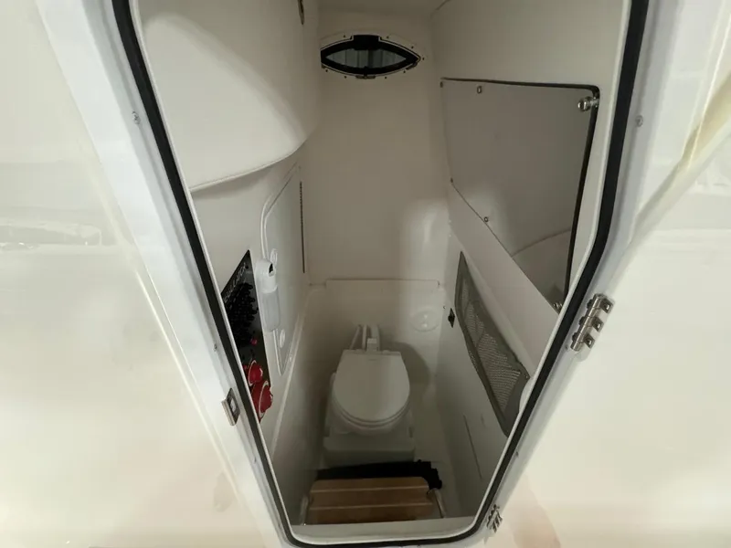 Slide: The Image of 2022 Regulator 25 boat interior with compact marine toilet. - 31