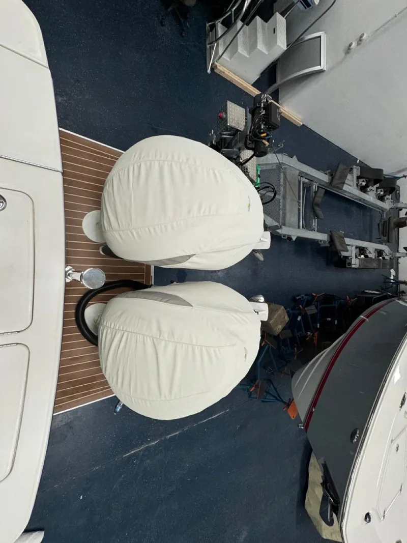 Slide: The Image of 2022 Regulator 25 boat with covered outboard motors in a storage facility. - 32