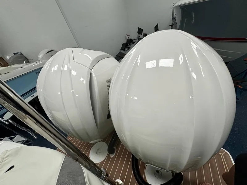Slide: The Image of 2022 Regulator 25 boat with dual outboard engines in a showroom. - 35