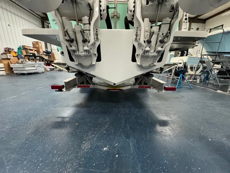Slide: The Image of 2022 Regulator 25 boat in a workshop, showing dual outboard motors. - 37