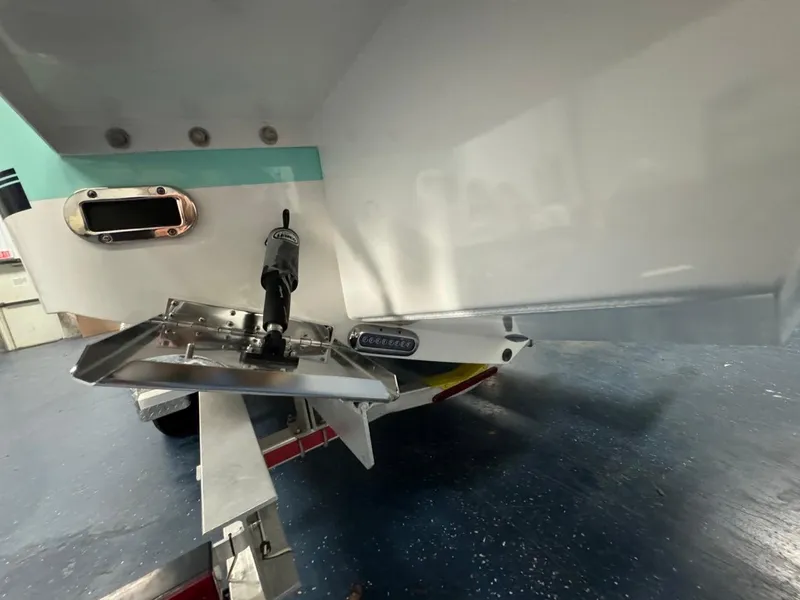 Slide: The Image of 2022 Regulator 25 boat stern with trim tab and trailer. - 38