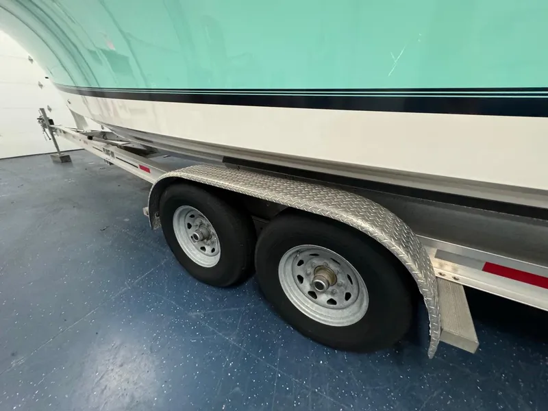 Slide: The Image of 2022 Regulator 25 boat on trailer with dual wheels in a garage. - 39