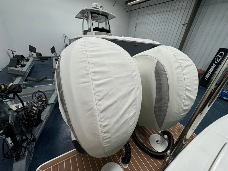 Slide: The Image of 2022 Regulator 25 boat with covered engines in a storage facility. - 4