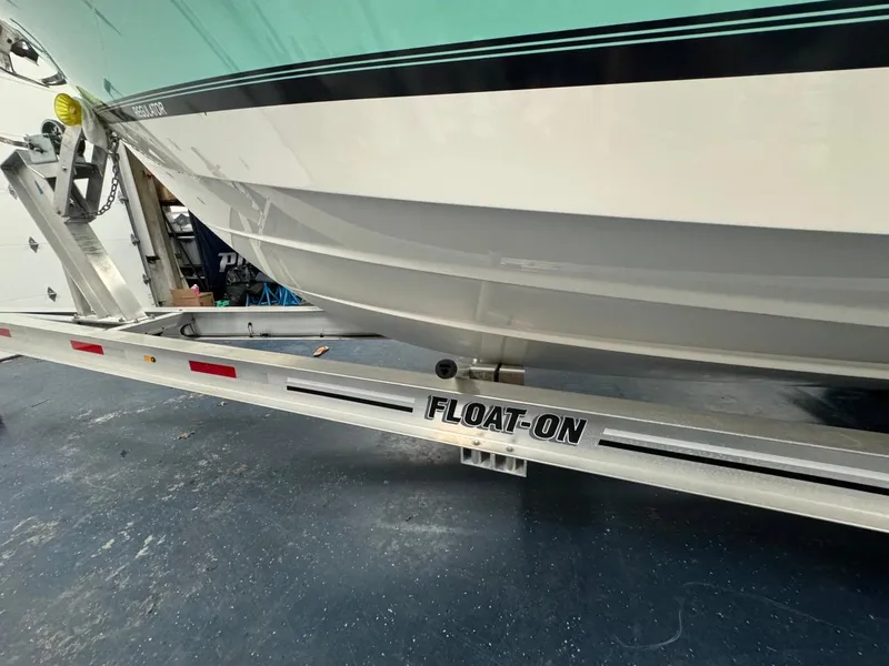 Slide: The Image of 2022 Regulator 25 boat on a Float-On trailer, close-up view. - 40